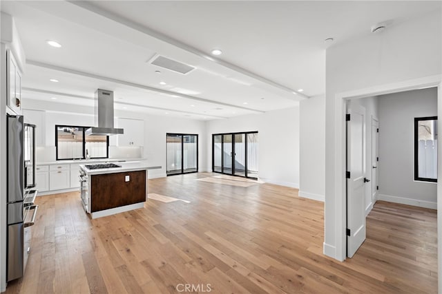 214 W Mariposa Unit B, San Clemente, CA 92672 - kitchen featuring island range hood, light wood finished floors, white cabinets, light countertops, and recessed lighting