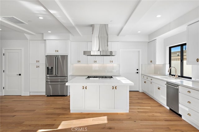 214 W Mariposa Unit B, San Clemente, CA 92672 - kitchen featuring appliances with stainless steel finishes, wall chimney range hood, beamed ceiling, light wood-style flooring, and a kitchen island