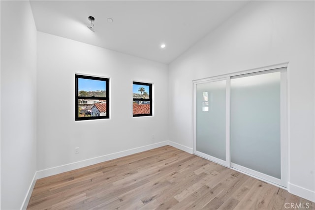214 W Mariposa Unit B, San Clemente, CA 92672 - unfurnished bedroom with light wood finished floors, vaulted ceiling, recessed lighting, and a closet