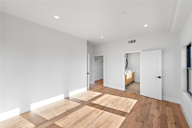 214 W Mariposa Unit B, San Clemente, CA 92672 - unfurnished bedroom with light wood-style floors, recessed lighting, a spacious closet, and ensuite bathroom