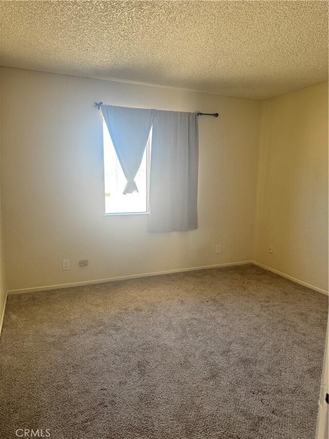 16840 Mackennas Gold Ave, Lake Los Angeles, CA 93591 - carpeted empty room featuring a textured ceiling