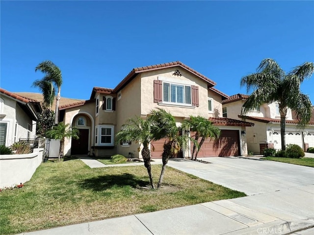 4717 Torrey Pines Dr, Chino Hills, CA 91709 - mediterranean / spanish-style house featuring a tiled roof, an attached garage, stucco siding, driveway, and a front lawn