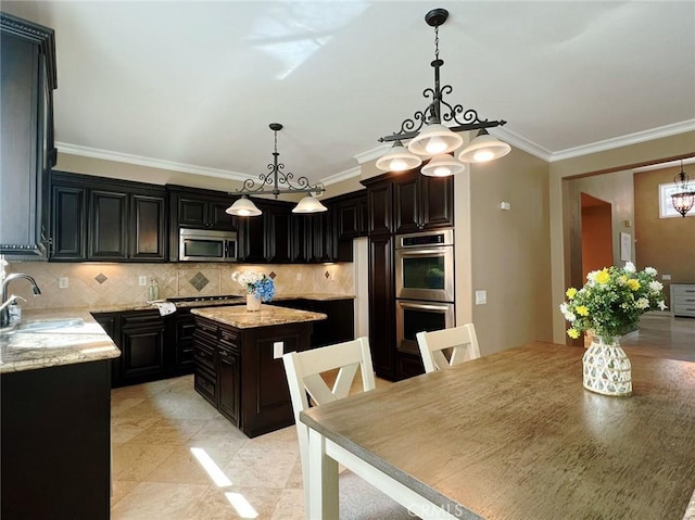4717 Torrey Pines Dr, Chino Hills, CA 91709 - kitchen featuring appliances with stainless steel finishes, a chandelier, decorative backsplash, crown molding, and light stone countertops