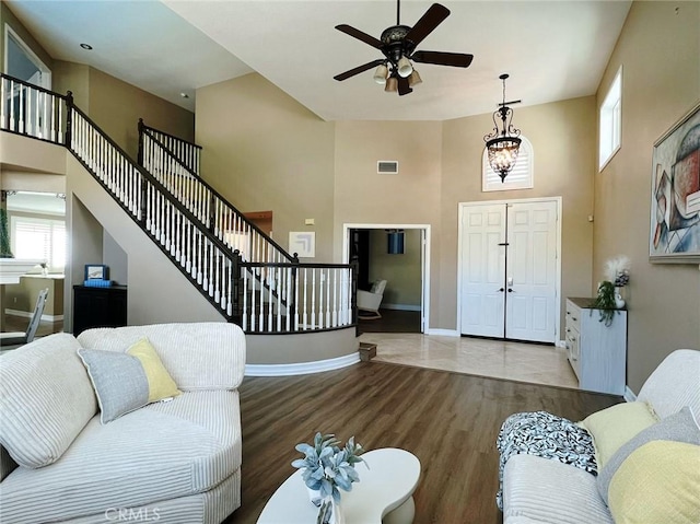 4717 Torrey Pines Dr, Chino Hills, CA 91709 - living area with a towering ceiling, wood finished floors, ceiling fan, plenty of natural light, and stairs