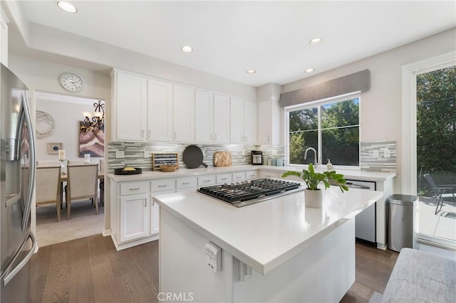 3 Heatherwood, Irvine, CA 92620 - kitchen featuring stainless steel appliances, dark wood-style floors, light countertops, white cabinetry, and decorative backsplash