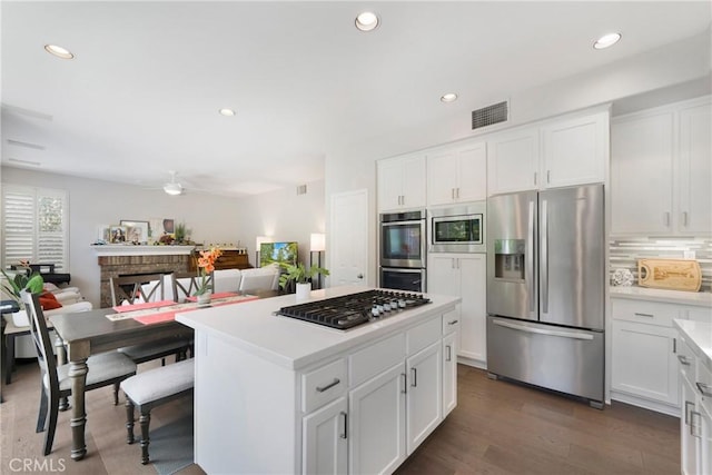 3 Heatherwood, Irvine, CA 92620 - kitchen with stainless steel appliances, a kitchen island, light countertops, white cabinets, and recessed lighting