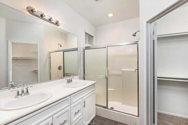 27569 Viridian St Unit 1, Murrieta, CA 92562 - full bathroom featuring a spacious closet, a stall shower, double vanity, and recessed lighting