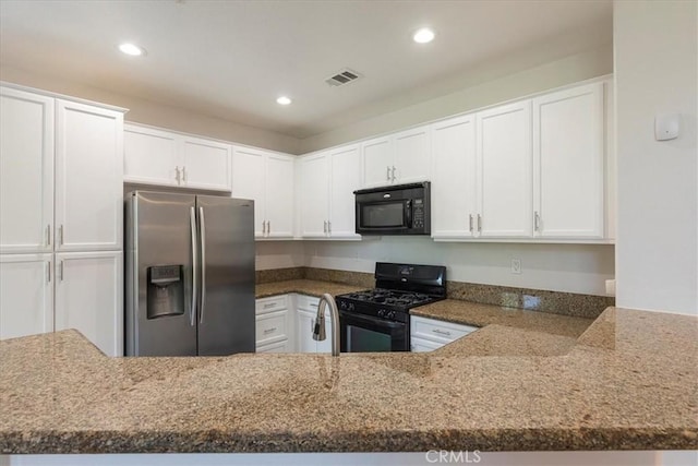 27569 Viridian St Unit 1, Murrieta, CA 92562 - kitchen with black appliances, stone countertops, white cabinetry, and recessed lighting