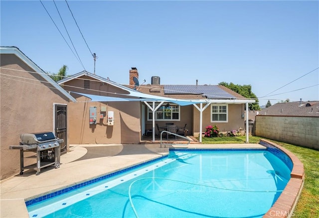 469 N Nearglen Ave, Covina, CA 91724 - rear view of house with solar panels, stucco siding, a patio, and a chimney
