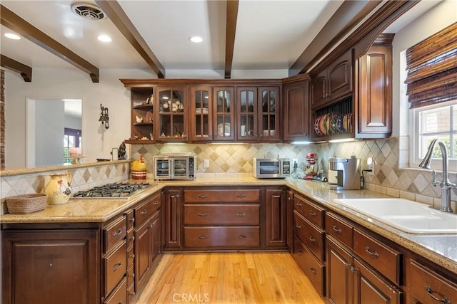 469 N Nearglen Ave, Covina, CA 91724 - kitchen featuring stainless steel appliances, beam ceiling, light wood-style flooring, a peninsula, and backsplash