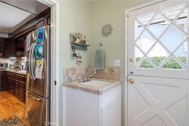 469 N Nearglen Ave, Covina, CA 91724 - kitchen featuring freestanding refrigerator, backsplash, dark brown cabinets, and tile countertops