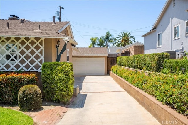 469 N Nearglen Ave, Covina, CA 91724 - view of side of property featuring a shingled roof, stucco siding, driveway, and a garage