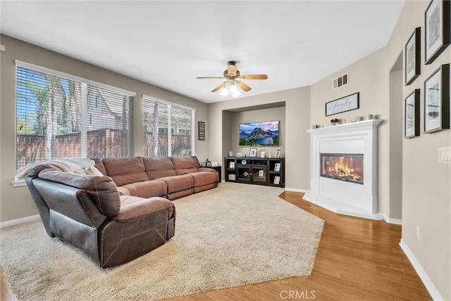 24934 Pine Creek Loop, Corona, CA 92883 - living area featuring ceiling fan, wood finished floors, and a glass covered fireplace