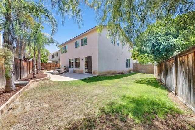 24934 Pine Creek Loop, Corona, CA 92883 - rear view of house with stucco siding, a patio, and a fenced backyard