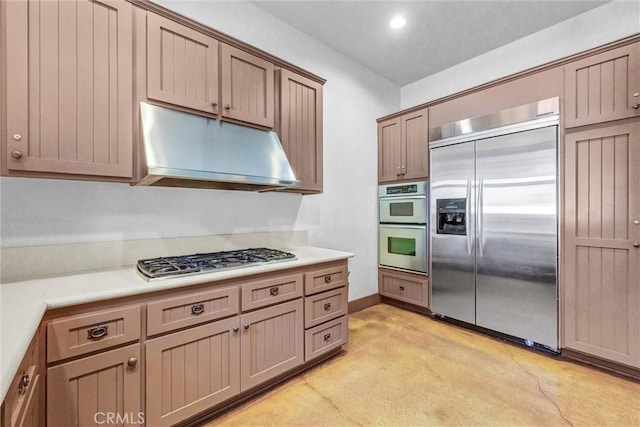 24934 Pine Creek Loop, Corona, CA 92883 - kitchen featuring appliances with stainless steel finishes, under cabinet range hood, light countertops, recessed lighting, and light carpet