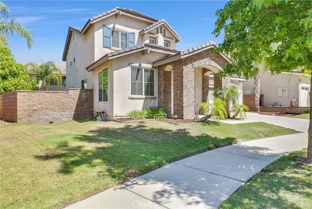 24934 Pine Creek Loop, Corona, CA 92883 - view of front of home with stucco siding, driveway, a front yard, and brick siding