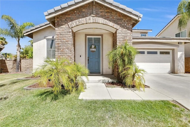 24934 Pine Creek Loop, Corona, CA 92883 - view of exterior entry with an attached garage, stucco siding, stone siding, concrete driveway, and a lawn