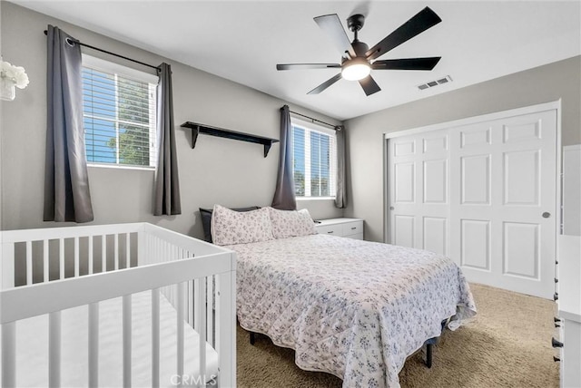 24934 Pine Creek Loop, Corona, CA 92883 - carpeted bedroom featuring multiple windows, a closet, and a ceiling fan
