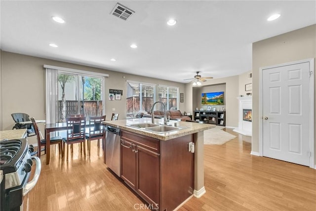 24934 Pine Creek Loop, Corona, CA 92883 - kitchen featuring stainless steel dishwasher, light wood-style floors, open floor plan, range with gas stovetop, and recessed lighting