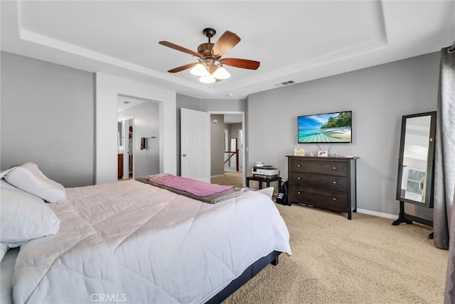 24934 Pine Creek Loop, Corona, CA 92883 - bedroom featuring a tray ceiling, light colored carpet, and a ceiling fan