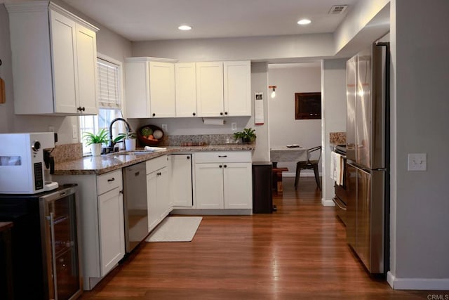 16320 Dartolo Rd, Ramona, CA 92065 - kitchen featuring stainless steel appliances, dark wood-style floors, beverage cooler, white cabinetry, and light stone countertops