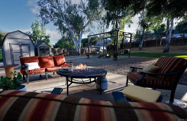 16320 Dartolo Rd, Ramona, CA 92065 - fenced backyard featuring a storage unit, a patio area, and an outdoor living space with a fire pit