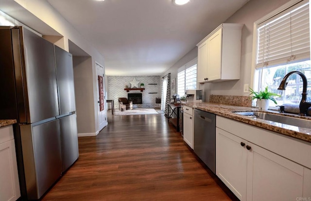 16320 Dartolo Rd, Ramona, CA 92065 - kitchen featuring stainless steel appliances, a fireplace, white cabinets, dark wood-type flooring, and light stone counters