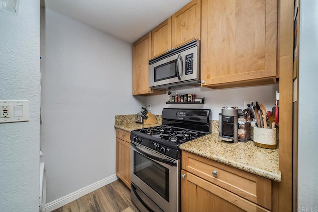 3773 1st Ave Unit 2, San Diego, CA 92103 - kitchen with stainless steel appliances, dark wood finished floors, and light stone counters