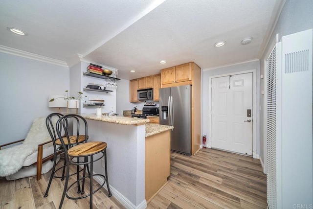 3773 1st Ave Unit 2, San Diego, CA 92103 - kitchen with appliances with stainless steel finishes, crown molding, a heating unit, a peninsula, and light wood-style flooring