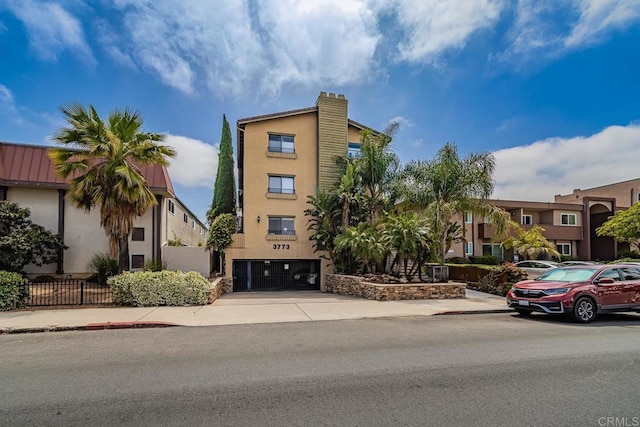 3773 1st Ave Unit 2, San Diego, CA 92103 - view of building exterior featuring an attached garage and concrete driveway
