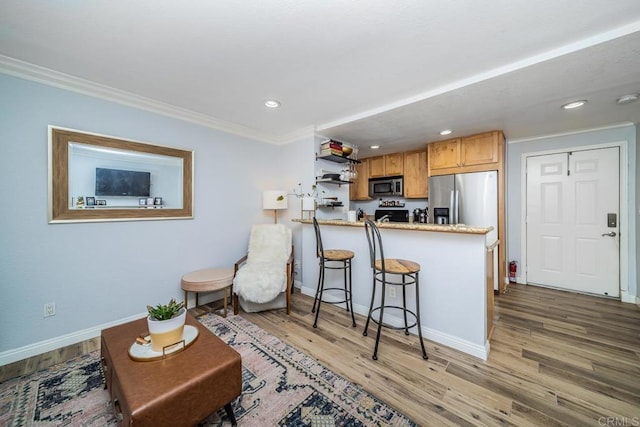 3773 1st Ave Unit 2, San Diego, CA 92103 - kitchen featuring stainless steel appliances, ornamental molding, recessed lighting, wood finished floors, and a peninsula