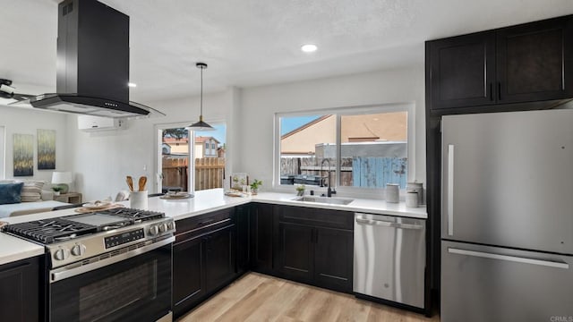 6117 Parkside Ave, San Diego, CA 92139 - kitchen featuring stainless steel appliances, island exhaust hood, dark cabinetry, light wood-style flooring, and recessed lighting