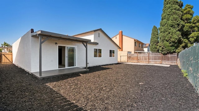 6117 Parkside Ave, San Diego, CA 92139 - back of house featuring a fenced backyard and stucco siding