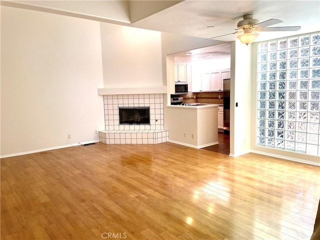 363 Cleo St, Laguna Beach, CA 92651 - unfurnished living room featuring ceiling fan, light wood-type flooring, and a fireplace
