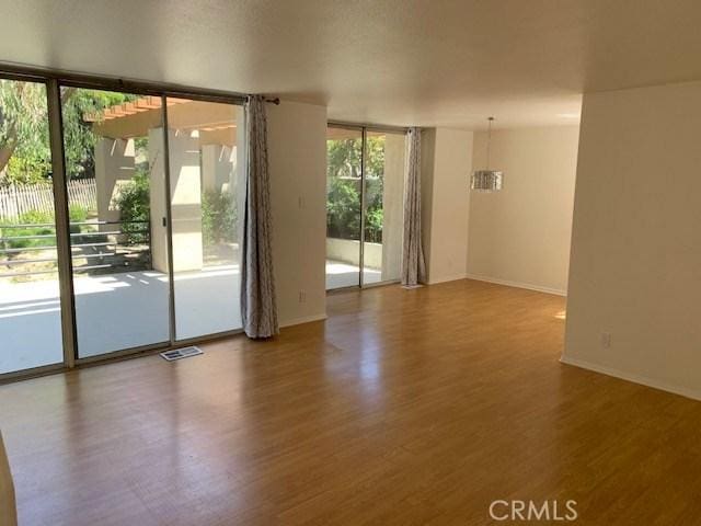 363 Cleo St, Laguna Beach, CA 92651 - unfurnished room featuring wood finished floors and a wall of windows