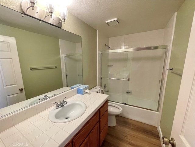 363 Cleo St, Laguna Beach, CA 92651 - full bath featuring wood finished floors, vanity, combined bath / shower with glass door, and a textured ceiling