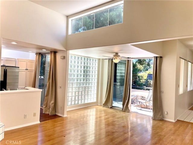 363 Cleo St, Laguna Beach, CA 92651 - unfurnished living room featuring a towering ceiling, light wood-style floors, and ceiling fan