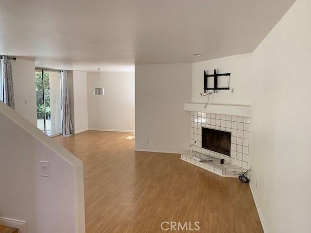 363 Cleo St, Laguna Beach, CA 92651 - unfurnished living room with wood finished floors and a tile fireplace