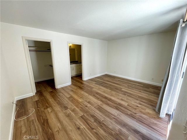 363 Cleo St, Laguna Beach, CA 92651 - unfurnished bedroom featuring wood finished floors, a spacious closet, and a closet