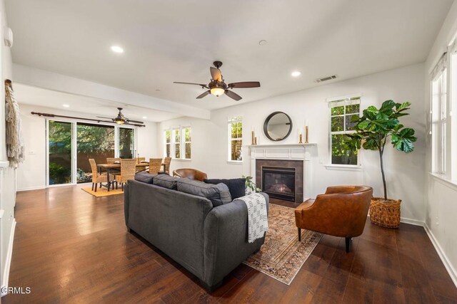 11570 Oakcrest Ave, Ojai, CA 93023 - living area with ceiling fan, a tiled fireplace, plenty of natural light, dark wood-style floors, and recessed lighting