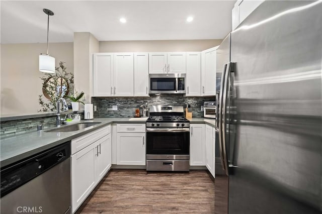 24545 Town Center Dr Unit 5201, Valencia, CA 91355 - kitchen featuring stainless steel appliances, backsplash, white cabinetry, decorative light fixtures, and recessed lighting