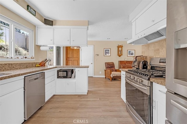360 Carpio Dr, Diamond Bar, CA 91765 - kitchen with stainless steel appliances, light wood-style floors, white cabinetry, light stone counters, and custom range hood