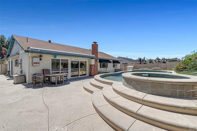 360 Carpio Dr, Diamond Bar, CA 91765 - rear view of property featuring an in-ground hot tub, a fenced backyard, a patio, a chimney, and stucco siding