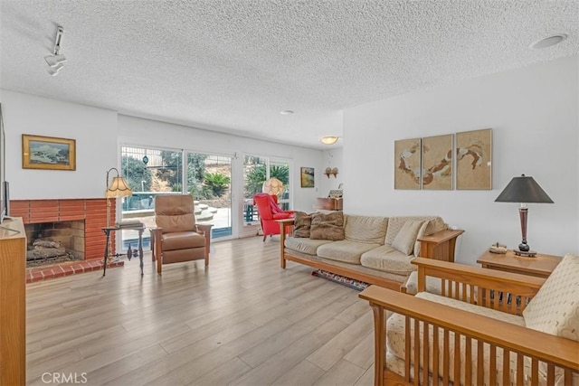 360 Carpio Dr, Diamond Bar, CA 91765 - living area featuring a textured ceiling, wood finished floors, and a fireplace