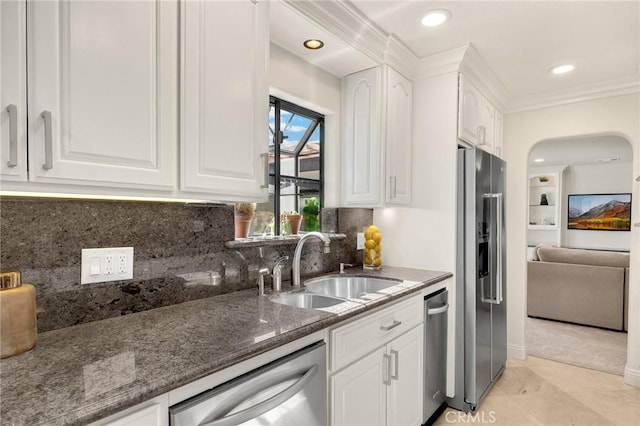 4161 Ricardo Dr, Yorba Linda, CA 92886 - kitchen with appliances with stainless steel finishes, dark stone countertops, white cabinets, crown molding, and backsplash
