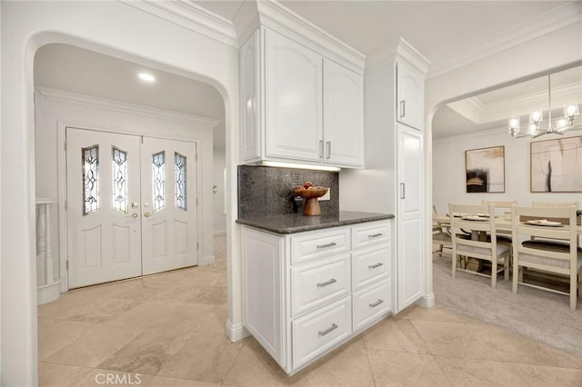 4161 Ricardo Dr, Yorba Linda, CA 92886 - kitchen featuring arched walkways, crown molding, white cabinets, and decorative backsplash