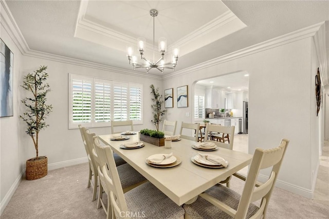 4161 Ricardo Dr, Yorba Linda, CA 92886 - dining space with a raised ceiling, arched walkways, light carpet, a chandelier, and ornamental molding