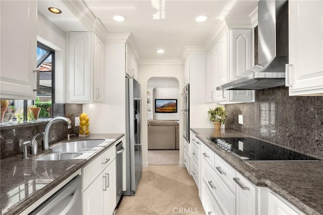 4161 Ricardo Dr, Yorba Linda, CA 92886 - kitchen with wall chimney exhaust hood, black electric cooktop, arched walkways, dishwashing machine, and white cabinetry