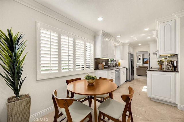 4161 Ricardo Dr, Yorba Linda, CA 92886 - dining space featuring arched walkways, crown molding, recessed lighting, and light tile patterned floors