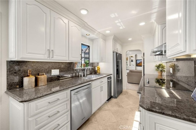 4161 Ricardo Dr, Yorba Linda, CA 92886 - kitchen featuring stainless steel appliances, arched walkways, decorative backsplash, white cabinets, and crown molding